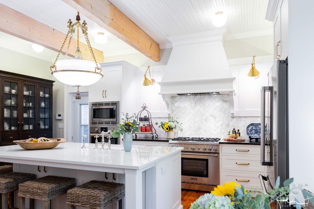 Easley, SC farmhouse kitchen remodeled by Renovus, preserving 1890s character with new cabinetry, quartz counters, and refinished pine floors